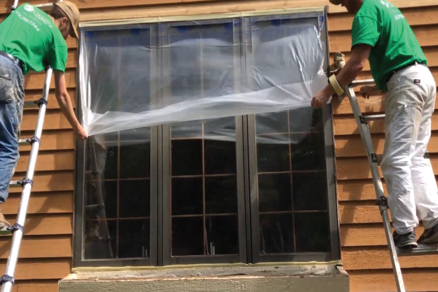 Covering exterior windows with plastic before painting