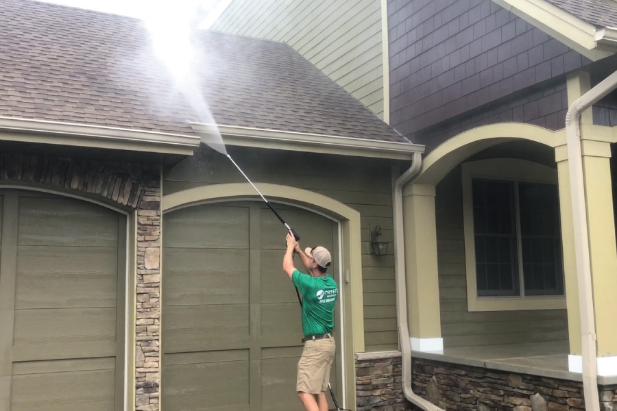 Pressure washing exterior home before painting